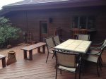 The outdoor dining table seats 6 guests with a BBQ grill